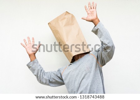 
    Funny people with paper bags.Using paper bags to reduce plastic bags.
People who are shocked.