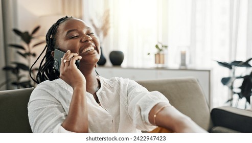 Funny, phone call and black woman on sofa, conversation or communication at home. Smartphone, talking and African person laughing, listening to story and comedy, chat or news and happy in living room - Powered by Shutterstock