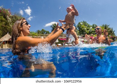 Funny Photo Of  Happy Active Family Young Mother With Active Baby Diving In Swimming Pool With Fun Jump . 