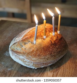 Funny Picture Of Artisanal Sourdough Golden Baked Crusty Bread With Birthday Candles On A Wooden Board