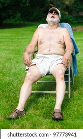 A Funny Picture Of An Older Shirtless Man Sleeping In A Folding Chair.