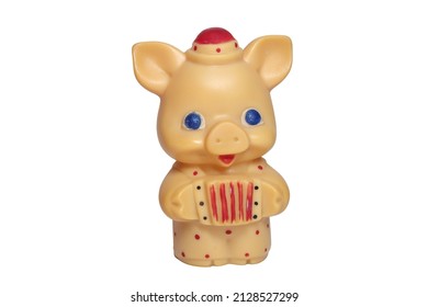 funny piglet with big blue eyes toy in little hat and colored polka dots jumpsuit, playing at concertina. on white background