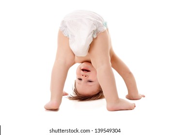 Funny Playing Baby Standing On His Head, Isolated On White