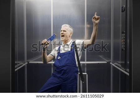Funny plumber singing in the elevator and using his water pump pliers as a microphone