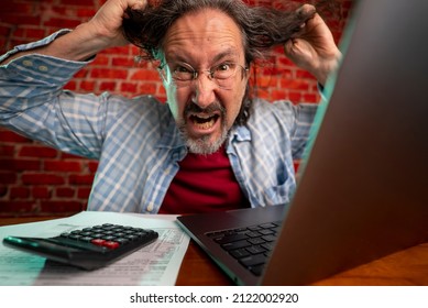 Funny Portrait Of Angry Crazy Man Pulling Hair Out Doing Tax Prep To Balance Budget Getting Debt Deficit Finding Mistake In Calculations. Annoyed Male Count Business Costs On Bankruptcy Risk