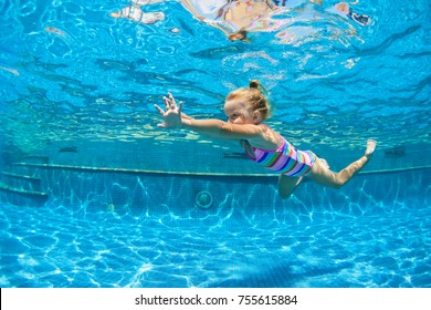 Funny Portrait Of Child Learn Swimming, Diving In Blue Pool With Fun - Jumping Deep Down Underwater With Splashes. Healthy Family Lifestyle, Kids Water Sports Activity, Swimming Lesson With Parents.