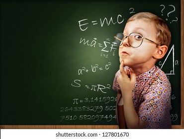 Funny portrait clever pupil boy on school board background