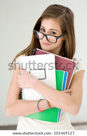 Funny portrait of eminent cute young brunette student girl.