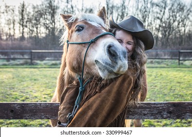 Funny portrait of a girl with an horse. Playing together at the farm. concept about people and animals - Powered by Shutterstock