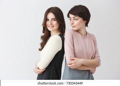 Funny Portrait Of Happy Lesbian Couple Posing Together In Matching Outfits Or University Graduation Album. Girl Trying To Repeat Her Girlfriend's Pose For Photo.