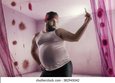 Funny Portrait Of A Plump Guy Taking A Selfie