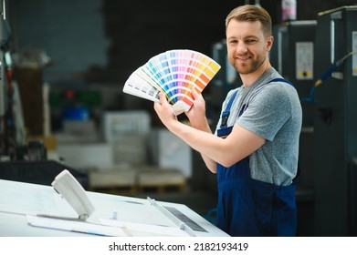 Funny portrait of typographer standing with color swatches at the printing manufacturing. - Shutterstock ID 2182193419