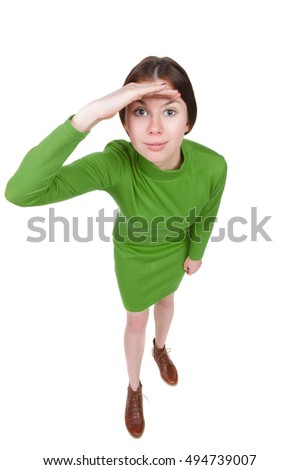 Funny portrait of a woman gazing into the frame. Wide-angle. Isolated over white background. A girl in a short green dress looks in the frame.