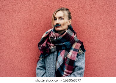 Funny portrait of a woman with a paper black mustache. Mask for carnival party.