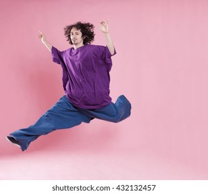 Funny portrait of a young man wearing a very large jeans and shirt. Conceptual image with weight loss themes.