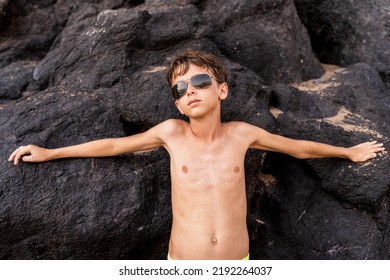 funny portrait of young shirtless man wearing sunglasses in an exotic beach - summer vacation concept - Powered by Shutterstock