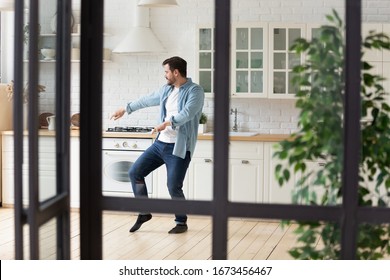 Funny Positive Man Dancing In Modern Kitchen Alone, Moving To Favorite Popular Music, Celebrating Relocation Or Weekend, Happy Handsome Guy Having Fun At Home, Enjoying Leisure Time