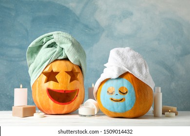 Funny pumpkins and skin care accessories on white background, copy space