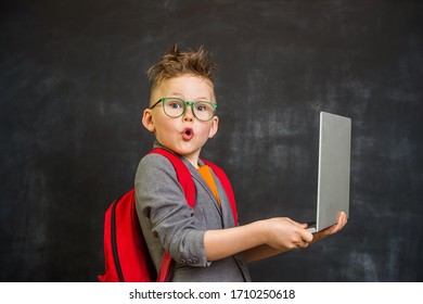 Funny Pupil Boy With Laptop In Hands. Back To School.