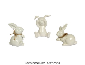 Funny rabbits ceramic with Easter eggs decorated with daisies on wooden background