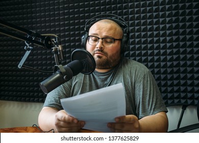 Funny radio presenter or host in radio station studio, portrait of working man