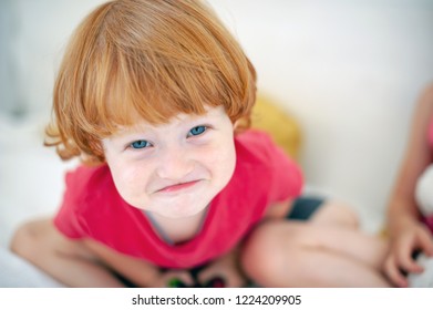 Funny Red-haired Boy Contorts His Face