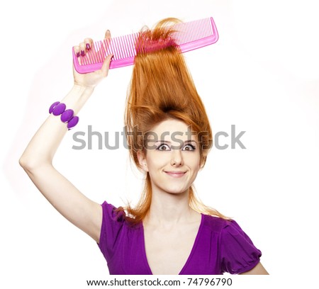 Funny red-haired girl with big comb.