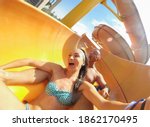 Funny scared couple on extreme water slide in aqua park
