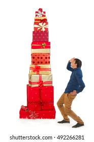 Funny Scene Of A Young Man Looking Up To A Huge Pile Of Christmas Presents