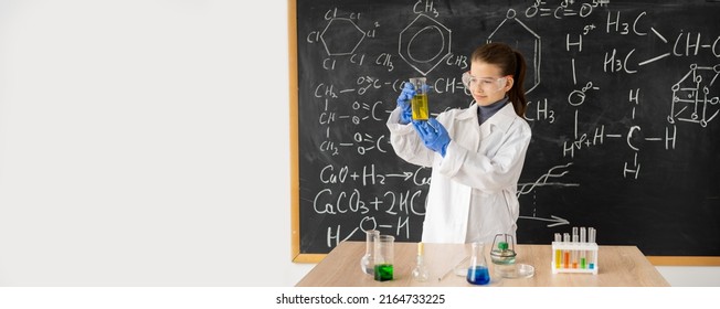 Funny Scientist Child With Glasses In Lab Coat With Chemical Flasks Having An Idea, School Blackboard Background With Science Formulas, Banner, Place For Text