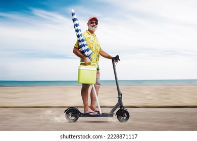 Funny senior man holding a beach umbrella and riding an electric scooter, he is going to the beach - Powered by Shutterstock