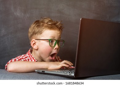 Funny shocked kid with a laptop. Protect child on homeschooling, 