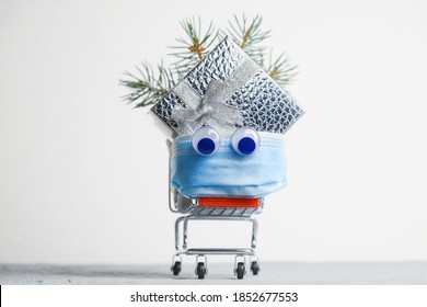 Funny Shopping Trolley With Eyes And Protective Medical Face Mask. Safety Christmas Shopping During Corona Virus Pandemic.