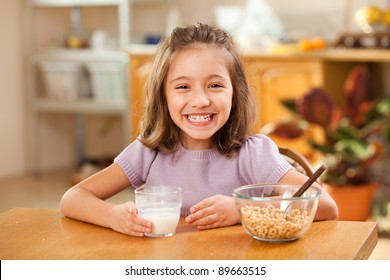funny shot of a little girl having breakfast: milk mustache