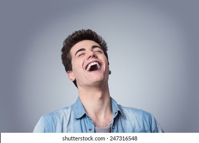 Funny smiling guy laughing out loud with closed eyes
