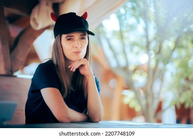 
Funny Smug Girl Smirking And Wearing A Hat With Devil Horns. Arrogant Infatuated Insufferable Girlfriend Acting Superior 
