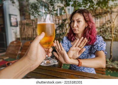 Funny Sober Woman Refuses An Extra Glass Of Beer At The Pub. Say No And Stop To Addiction And Excessive Alcohol Consumption.