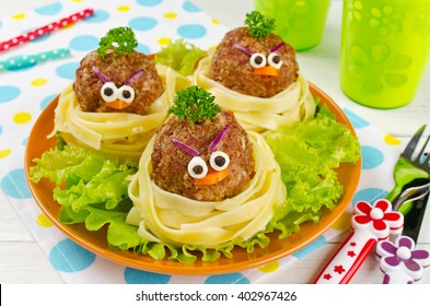 Funny spaghetti with meatballs for kids. Birds in nests