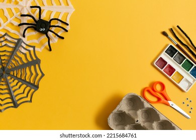 Funny Spider From Egg Carton Packaging And Materials  On Yellow Background With Copy Space. Children's Craft For Halloween Party. Simple DIY, Creative Eco Friendly Idea, Reuse  And Zero Waste Concept.