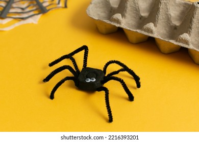 Funny Spider From Egg Carton Packaging On Yellow Background. Children's Craft For Halloween Party. Simple DIY, Creative Eco Friendly Idea, Reuse And Zero Waste Concept.