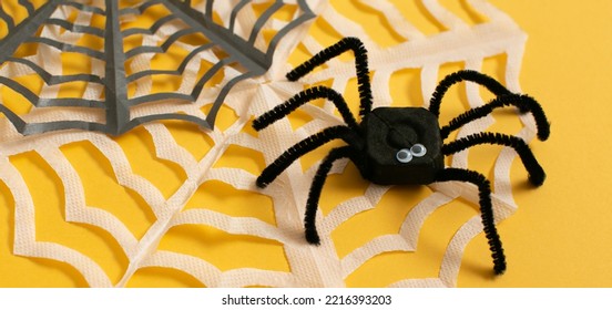 Funny Spider From Egg Carton Packaging With Web On Yellow Background As Banner. Children's Craft For Halloween Party. Simple DIY, Creative Eco Friendly Idea, Reuse, Zero Waste Concept.