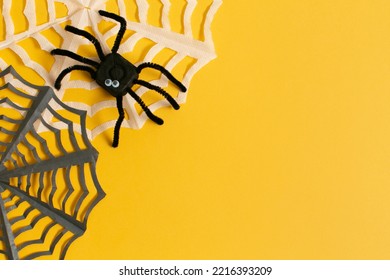 Funny Spider From Egg Carton Packaging With Web On Yellow Background With Copy Space. Children's Craft For Halloween Party. Simple DIY, Creative Eco Friendly Idea, Reuse, Zero Waste Concept