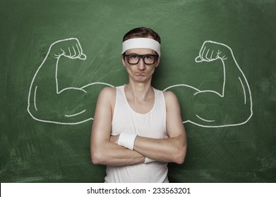 Funny sport nerd with huge, fake, muscle arms drawn on the chalkboard