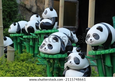 funny statues of pandas who are busy with their own business