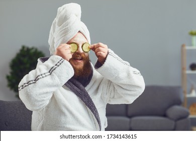 Funny Strange Fat Bearded Man With A Cosmetic Mask On His Face In A Bathrobe Does Spa Treatments On His Face Rests In A Room At Home