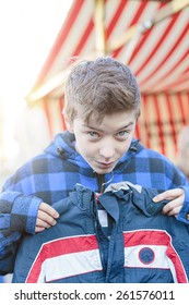 Funny Teenage Boy On A Flea Market Is Trying Too Small Dresses