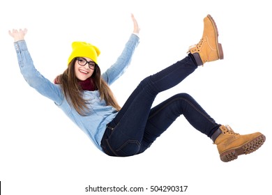 funny teenage girl falling down in winter clothes isolated on white background