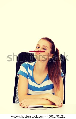 Funny teenage woman doing mustache from pen