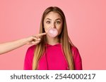 Funny teenager girl blowing bubble of chewing gum