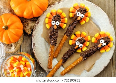 Funny Thanksgiving Turkey Pretzel Rods With Candy Corn, Overhead Scene On Old Wood